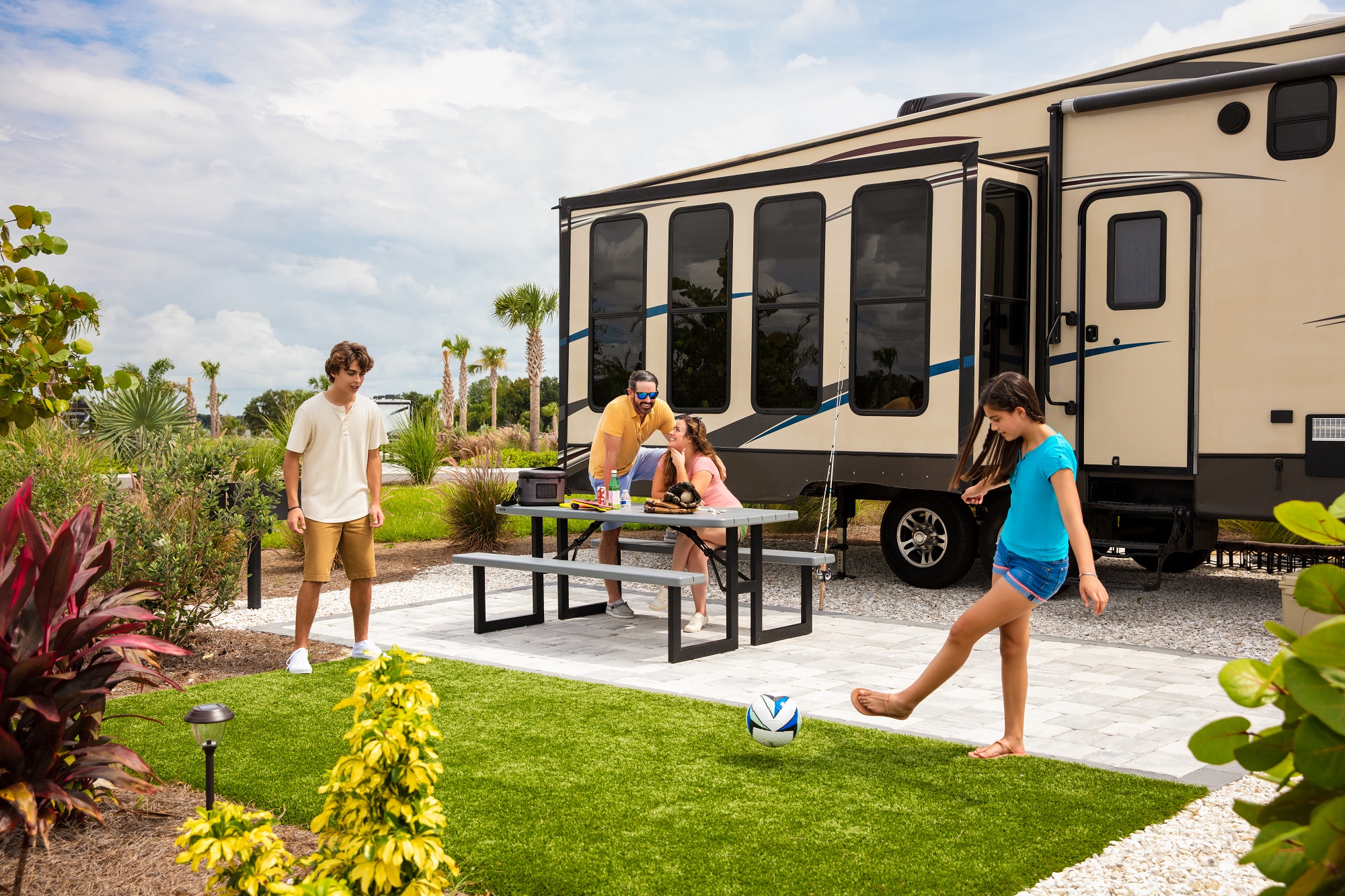 Kids playing soccer in front of an RV at Camp Margaritaville Auburndale