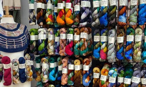 wall of colorful twisted yarn bundles at Four Purls Yarn Shop in Winter Haven, FL