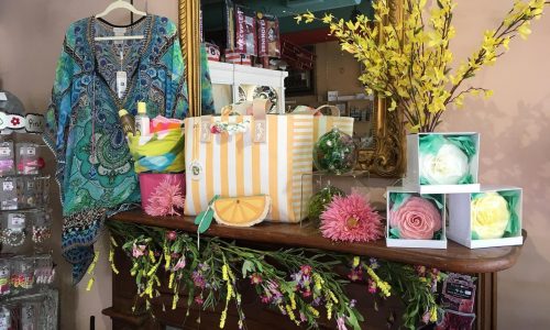 wooden mantel with flowers and merchandise on it at Little Studios Interiors in Winter Haven, FL
