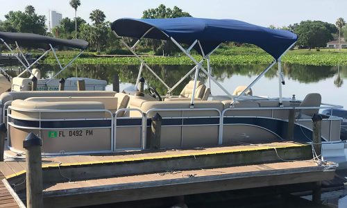 rental pontoon boat on lake at dock
