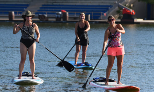 3 girls paddle boarding in winter haven