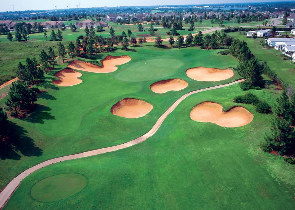 tree lined fairway with bunkers at Southern Dunes Golf & Country Club in Haines City, FL