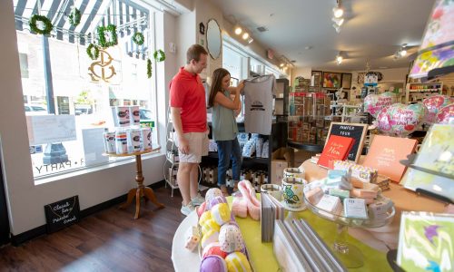 Couple looking at Lakeland themed t-shirt inside Stationery Loft and Gift Boutique in Lakeland, FL