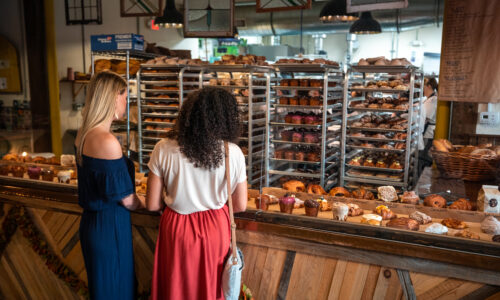 Two girls ordering at Born and Bread Bakehouse during their weekend in Lakeland