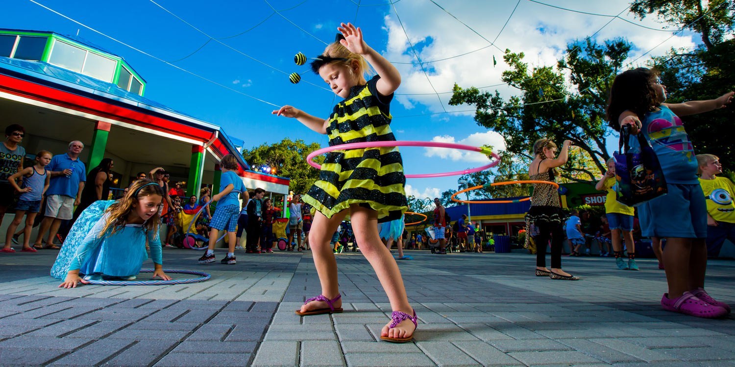 kid wearing a honey bee costume, hula hooping during Brick or Treat at at LEGOLAND Florida Resort