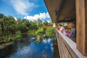 Family looking over lake behind Polk County's main Visitor Services building in Davenport, FL