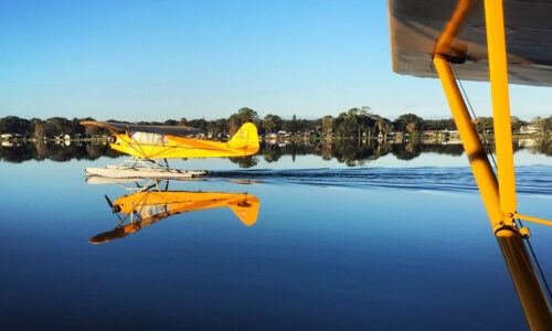 yellow seaplane taking off in lake at Jack Brown's Seaplane Base in Winter Haven, FL