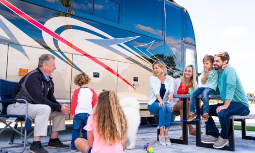 multi-generation family and dog sitting outside motorhome at Cabana Club RV Resort in Auburndale FL