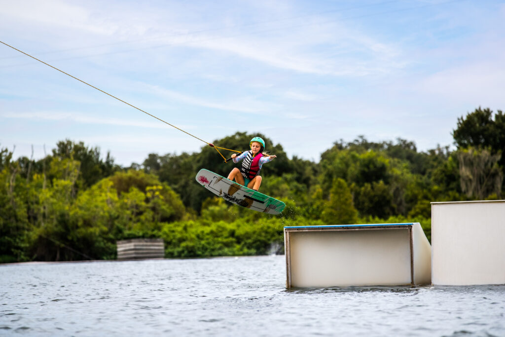 Things To Do On The Water in Central Florida include: Kid wakeboarding at ECP