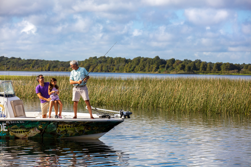 Multigenerational familing fishing from a boat on Lake Kissimmee