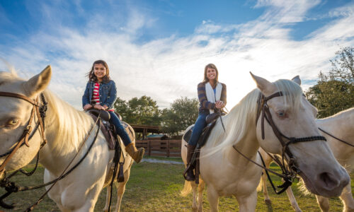 Mother and daughter on horses at River Ranch